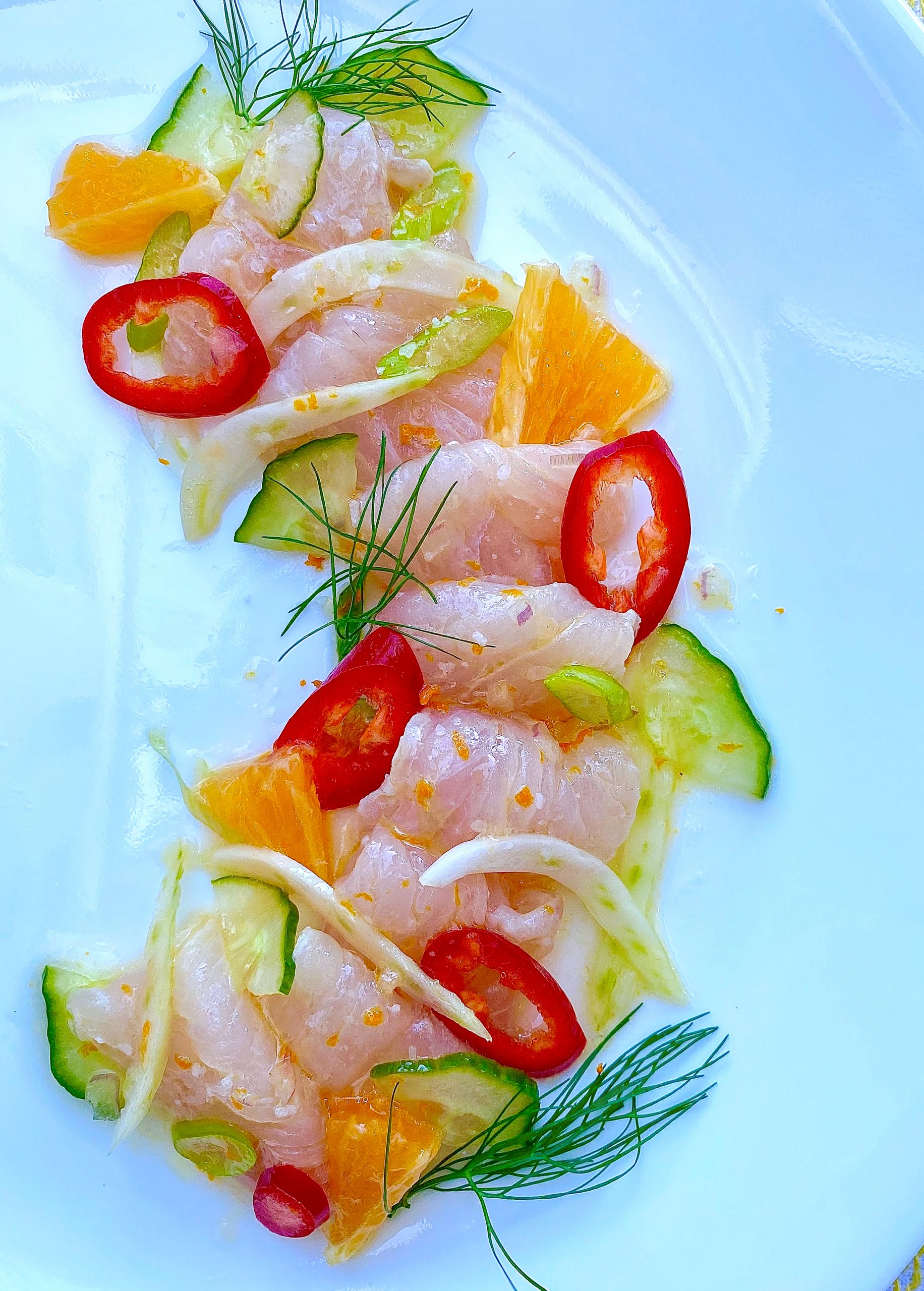 Yellowtail Crudo on a white plate